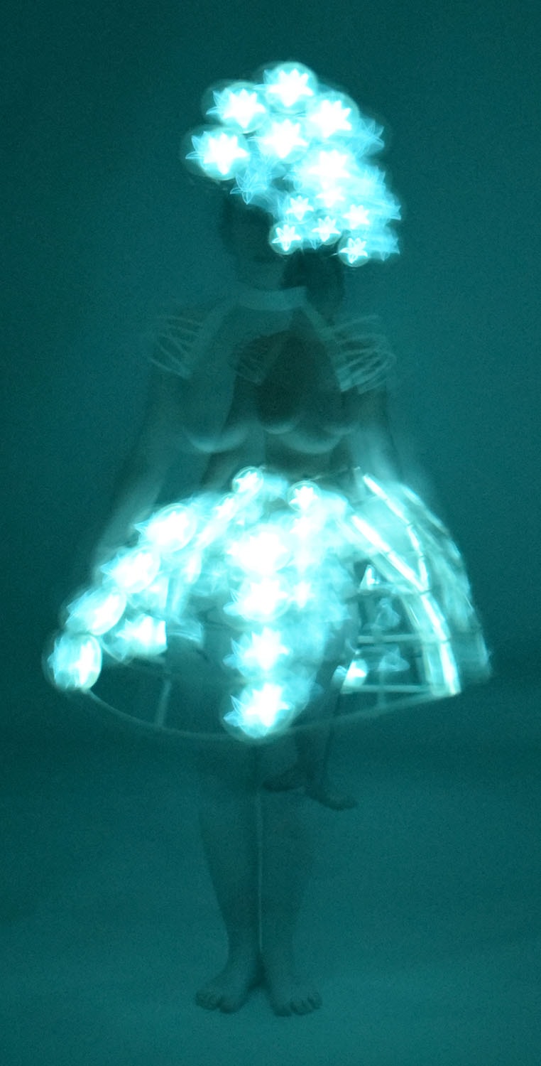 Two Women in One, a figure with glowing floral bioluminescent forms