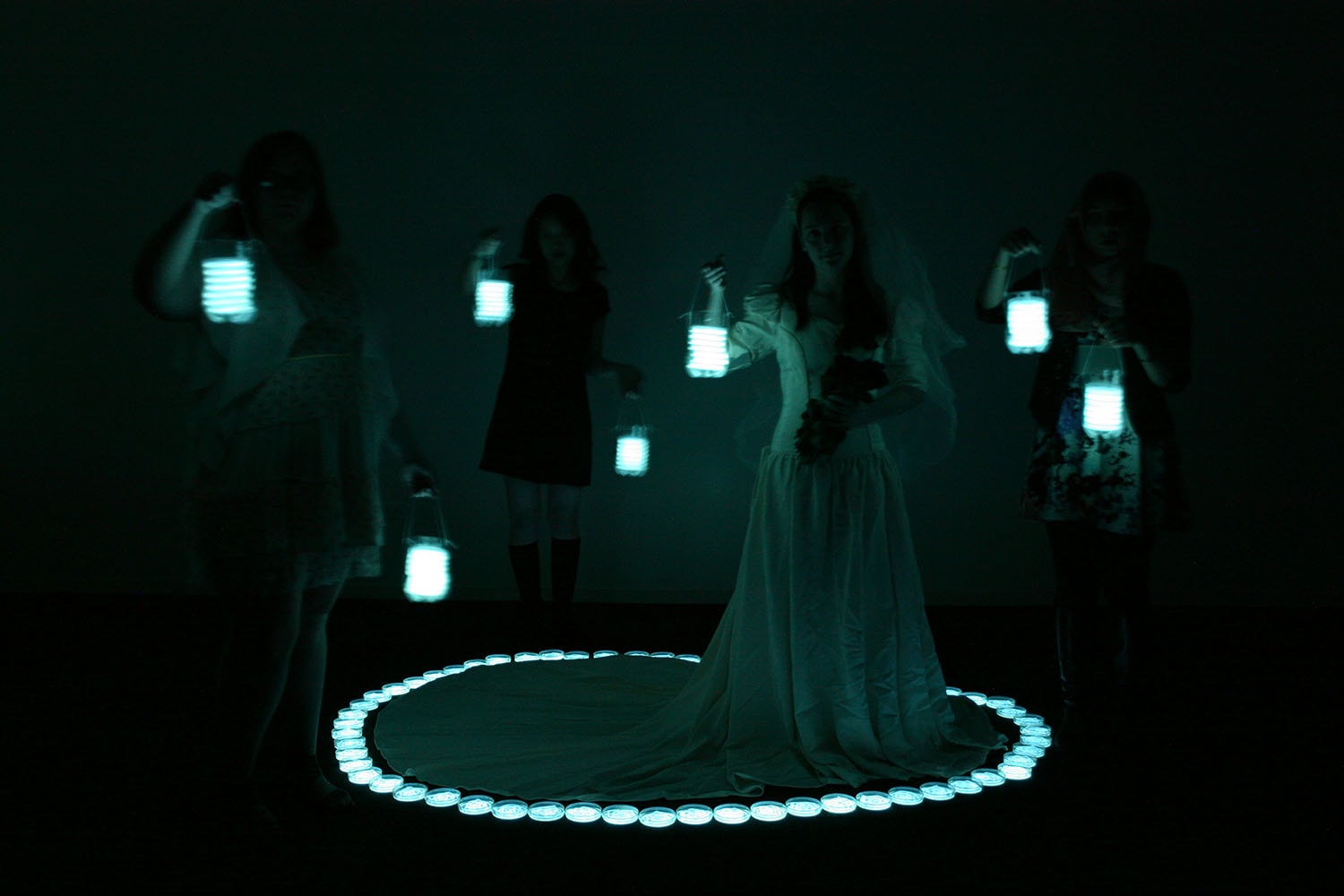 Bridal Party, performers carrying glowing lanterns around a circular light installation